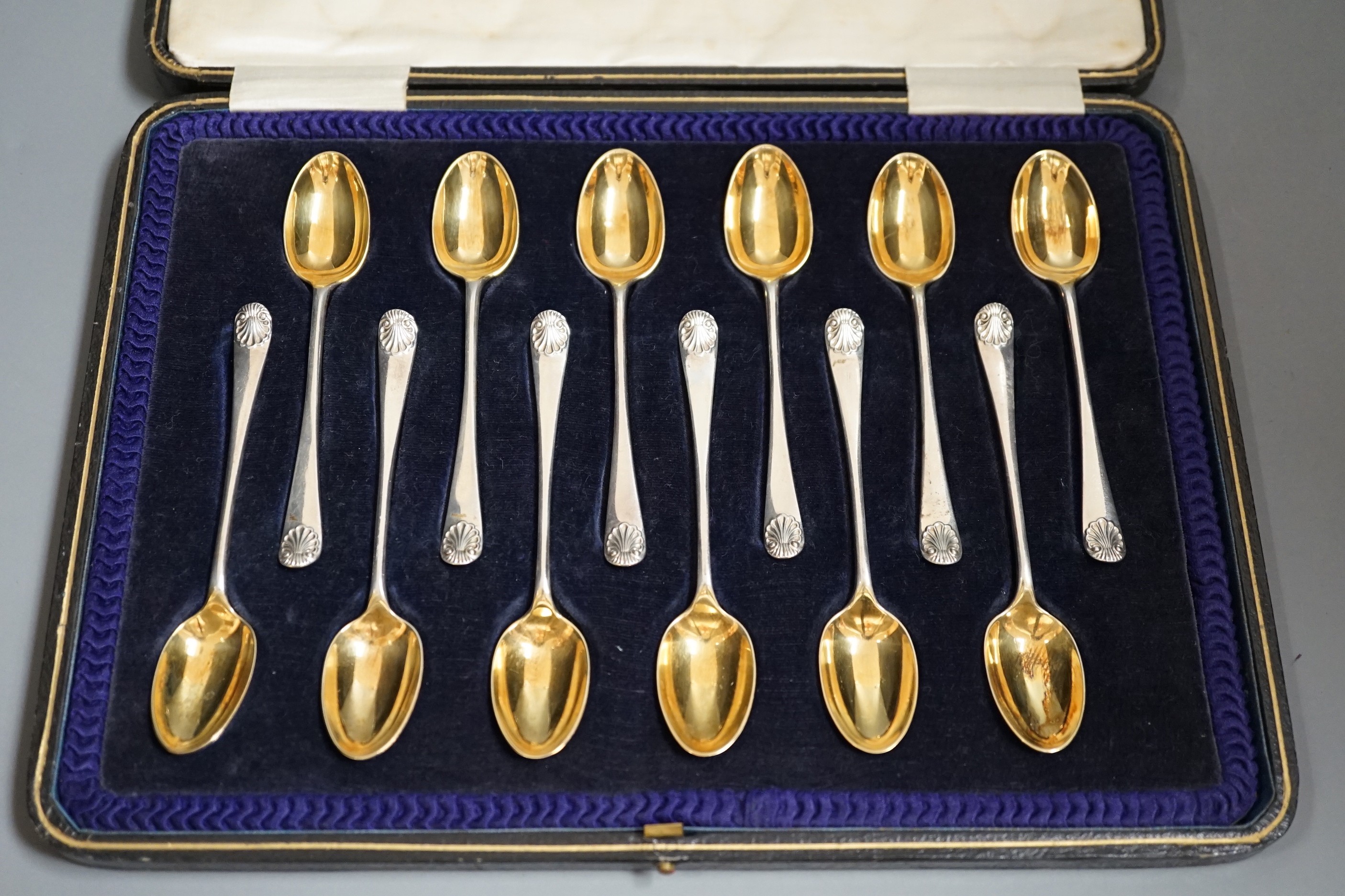 A cased set of twelve late Victorian silver 'picture back' coffee spoons, by Thomas Bradbury & Sons, London, 1896, 11.1cm.